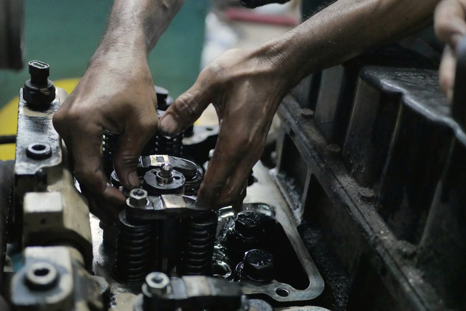 Two hands fitting a part onto an engine block